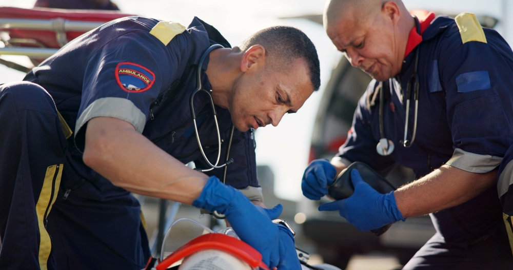 First responders providing urgent care in an auto accident scenario.