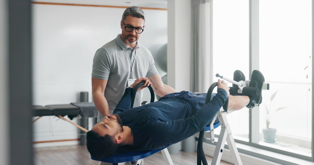 A man in a physical therapy session focused on healing from a slip and fall incident.